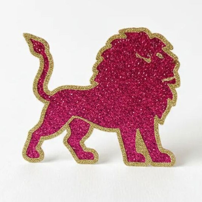 A pink glitter lion figure is depicted against a white background.