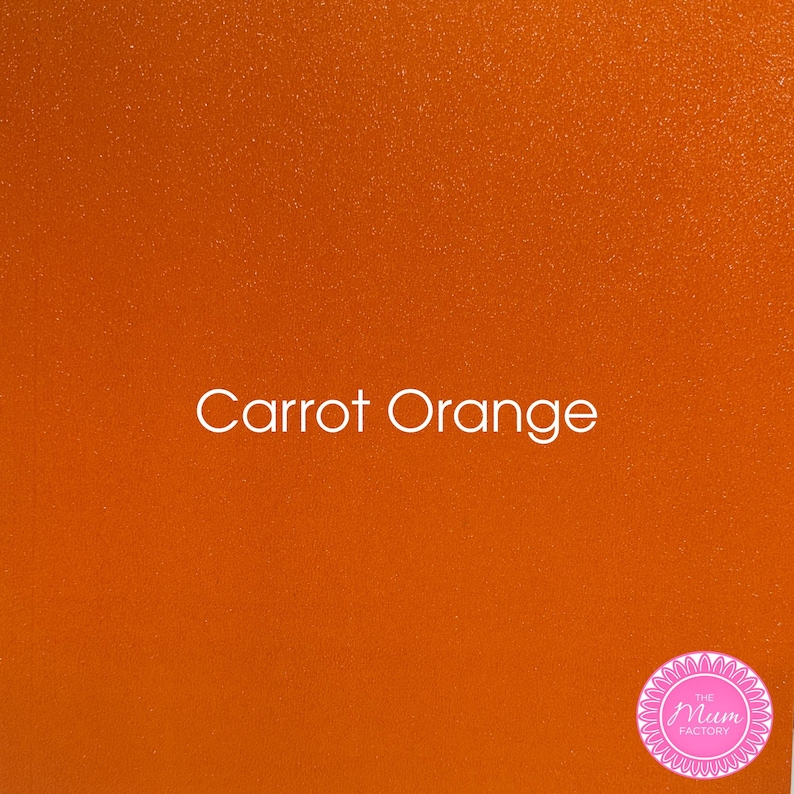 May include: A square sheet of carrot orange material with a fine glittery texture. The text "Carrot Orange" is printed in white in the center. A circular pink logo with the text "The Mum Factory" is located in the bottom right corner.