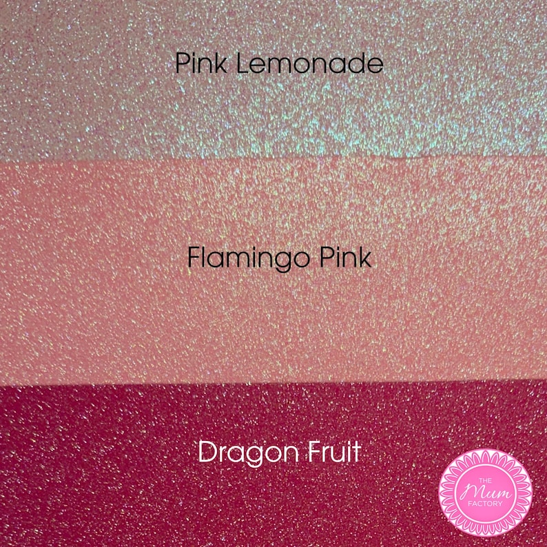 May include: Three horizontal bands of glittery material in varying shades of pink. The top band is labeled Pink Lemonade, the middle band is labeled Flamingo Pink, and the bottom band is labeled Dragon Fruit. A circular logo for The Mum Factory is visible.