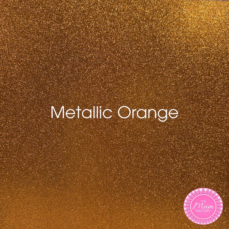 May include: A sheet of metallic orange glitter material with a dense, sparkling texture. The text Metallic Orange is printed in white in the center. A circular pink logo with the text The Mum Factory is located in the bottom right corner.
