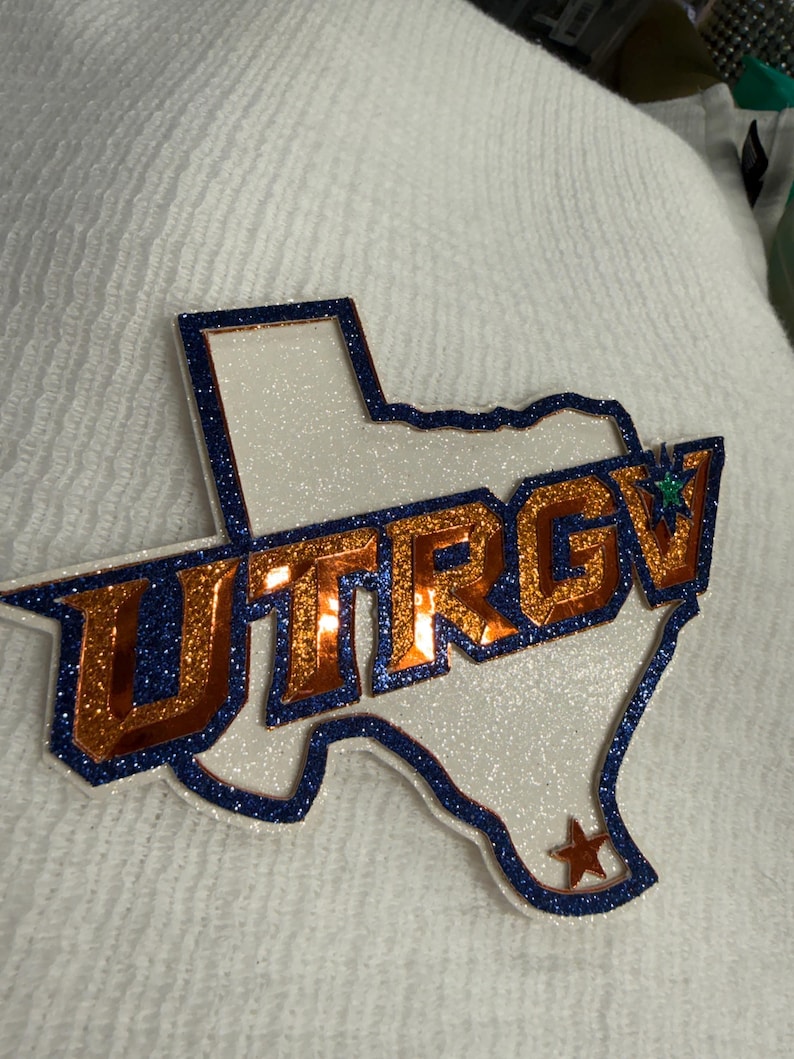 A close-up of a glittery, glittery logo on a white background.