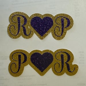 two glittery heart-shaped objects with the letters "R" and "P" on them, placed on a white background.