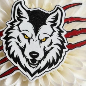 A white flower with a stylized black and white wolf head on it, surrounded by red spikes.