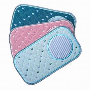 Peut inclure: Trois tapis rectangulaires matelassés en bleu sarcelle, rose et bleu clair, chacun avec un motif de cœur et un motif circulaire à rayures. Les tapis ont un motif de point de diamant et une bordure contrastante.