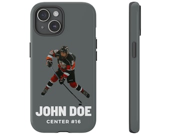 May include: A gray phone case with a hockey player in a black and red jersey. The player is holding a hockey stick and is skating on the ice. The text "JOHN DOE CENTER #16" is printed on the case.
