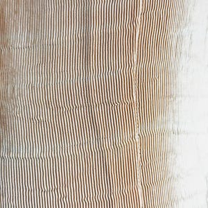 May include: Close-up of a textured fabric with vertical stripes. The stripes transition from a warm brown to a white color, creating a gradient effect. The fabric appears to be soft and possibly quilted.