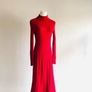May include: A red ribbed knit midi dress with a turtleneck.