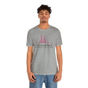 May include: A heather grey t-shirt with a pink silhouette of two people walking hand-in-hand. The text "Introverted But willing to discuss C-Drama" is printed below the silhouette.