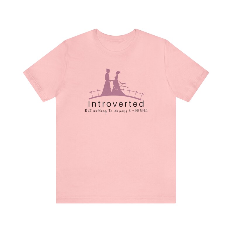 May include: Pink t-shirt with a graphic of a couple on a bridge and the text "Introverted But willing to discuss C-DRAMA".