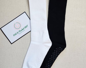 May include: A pair of socks, one white and one black, with grippy dots on the bottom of the black sock.