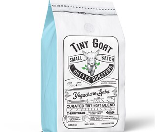 Puede incluir: Una bolsa blanca de café en grano entero con un borde azul. La bolsa presenta un logotipo de una cabra con el texto "Tiny Goat Small Batch Coffee Roasters". La bolsa también incluye el texto "Yogachara Baba Curated Tiny Goat Blend" y "Fair Trade".