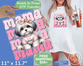 May include: A pink and white DTF transfer design featuring a cartoon Shih Tzu dog wearing a pink shirt with the words "I love Mom" on it. The dog is surrounded by the word "mama" in pink letters.