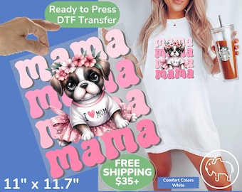 May include: A white Comfort Colors t-shirt featuring a graphic of a puppy wearing a floral crown and tutu, with the text "mama" in pink. The DTF transfer measures 11" x 11.7". The puppy wears a shirt that says "I ❤️ MOM".