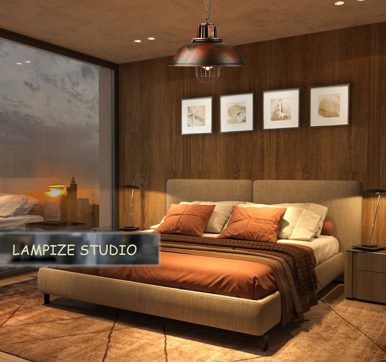 May include: A bedroom with a large bed with a brown comforter and a brown and beige headboard. The bed has a few pillows on it. There is a large window behind the bed with a view of a city skyline at sunset. There is a brown ceiling light fixture hanging from the ceiling above the bed. The text "LAMPIZE STUDIO" is visible in the lower left corner of the image.