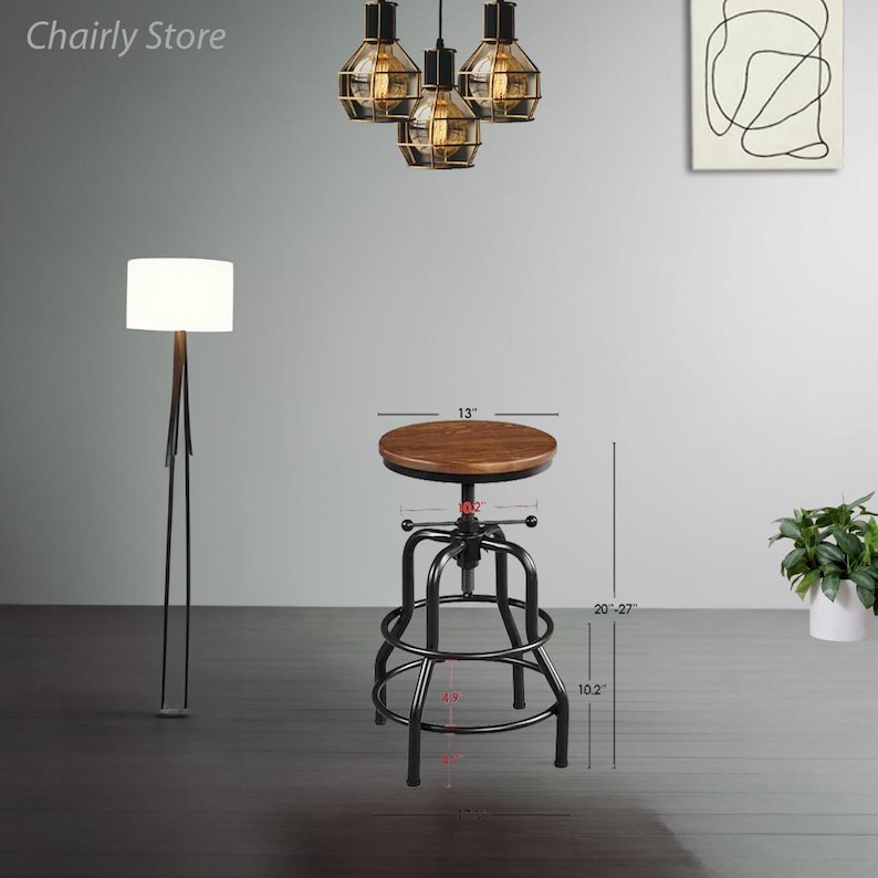 May include: A black metal adjustable height bar stool with a brown wooden seat. The stool is 51-69 cm tall and has a 33 cm diameter seat. The stool is 26 cm wide and has a 7.6 cm diameter base.
