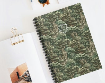 May include: A green spiral notebook with a geometric pattern of trees and a white geometric shape in the center. The notebook has a black wire-o binding.