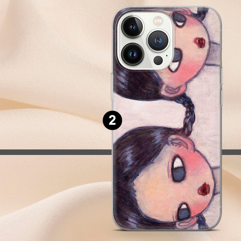May include: A clear phone case with a colorful illustration of two girls with pigtails. The girls have large eyes and red lips. The case is designed for an iPhone with a camera bump.