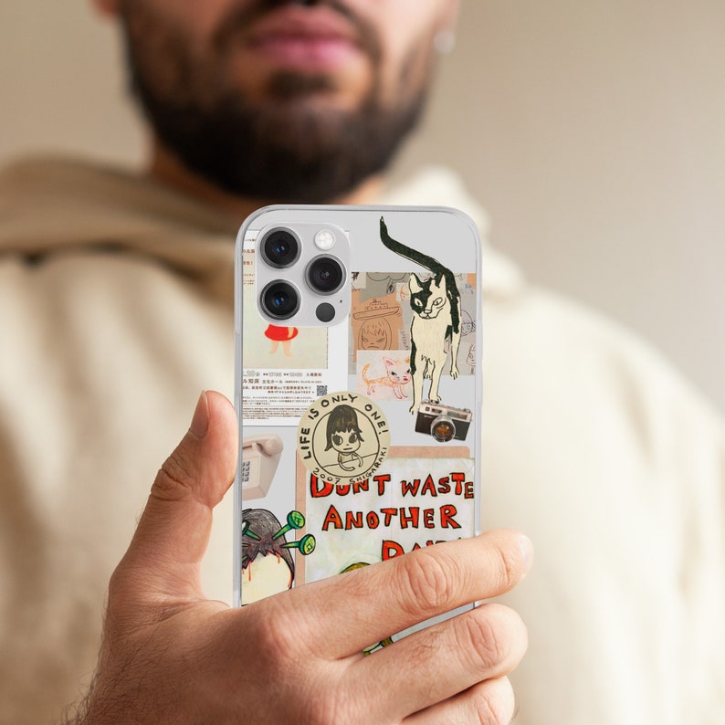 May include: A clear phone case with a variety of colorful stickers. The stickers feature a cat, a girl, a camera, and text that says "Life is only one! Don't waste another day."