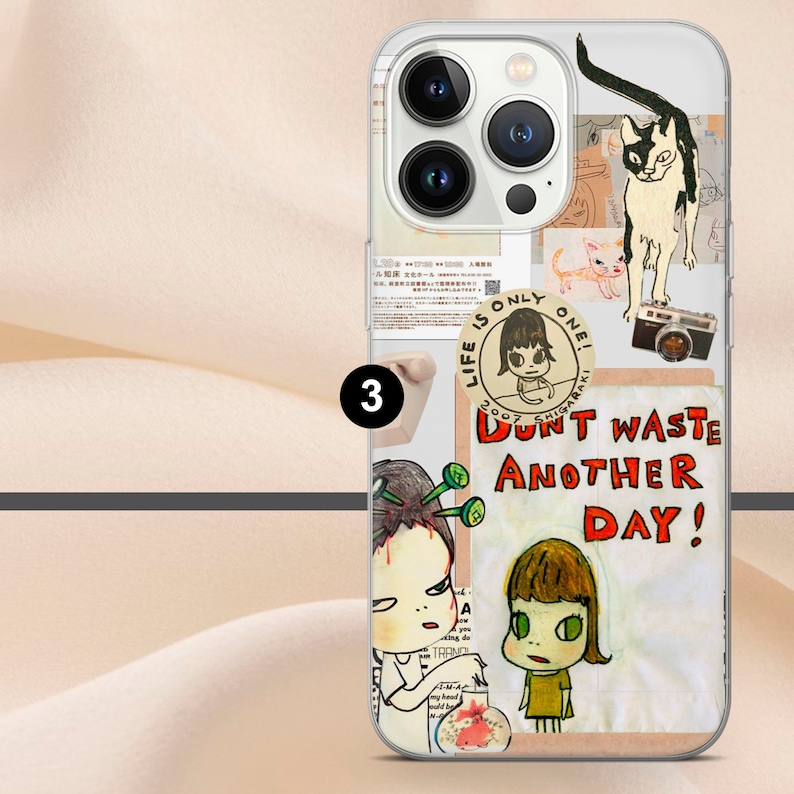 May include: A clear phone case with a variety of colorful stickers. The stickers feature illustrations of cats, people, and text. The text on the stickers reads "Life is only one!" and "Don't waste another day!"