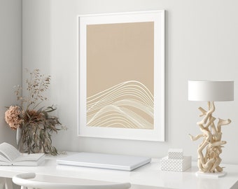 May include: A white desk with a white chair, a laptop, a book, a lamp with a white shade and a driftwood base, and a framed print with a beige background and white abstract lines.