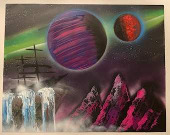 May include: A spray-painted artwork showing a cosmic scene. Two planets, one purple and one red, are set against a starry night sky with a green and purple aurora. The foreground features mountains and a waterfall.
