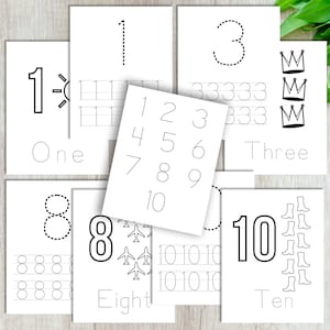 May include: A collection of white flashcards with black outlines of numbers and corresponding illustrations. The cards display numbers one through ten, with dotted lines for tracing. The word for each number is also printed on the cards.