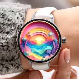 May include: A silver smartwatch with a white band displays a colorful tropical scene. The watch face features a rainbow, palm trees, and a sunset over the ocean. The watch is worn on a wrist.