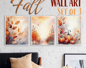 May include: Set of three framed wall art prints with a fall theme. The prints feature watercolor illustrations of autumn leaves, trees, and pumpkins in shades of orange, red, and brown. The words "Fall" and "WALL ART SET OF 3" are above the prints.