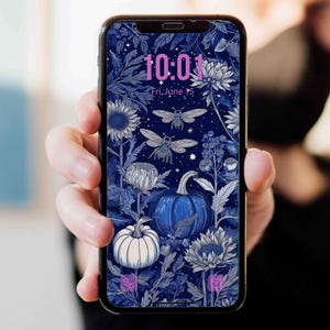 May include: A smartphone displaying a digital wallpaper with a dark blue background featuring white and blue botanical illustrations of pumpkins, sunflowers, and bees. The screen shows the time 10:01 and the date Fri, June 15 in pink text.