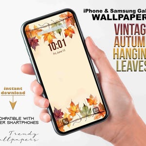 Puede incluir: Un teléfono inteligente muestra un fondo de pantalla vintage de otoño con hojas colgantes en tonos rojos, naranjas y amarillos. La pantalla muestra la hora 10:01 y la fecha, viernes 15 de junio. El texto en la imagen dice "iPhone & Samsung Galaxy Wallpaper".