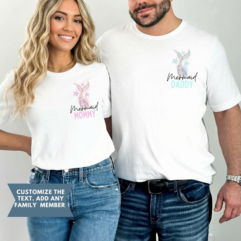 May include: White t-shirts with mermaid tail graphics and text. One shirt says "Mermaid Mommy" in pink, the other says "Mermaid Daddy" in blue. The shirts are worn by two people, one with blonde hair and the other with dark hair.
