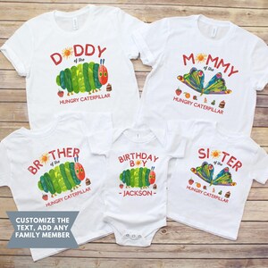 Może przedstawiać: Białe koszulki i body z kolorowymi ilustracjami gąsienicy i motyla z książki "The Very Hungry Caterpillar". Tekst zawiera "Daddy", "Mommy", "Brother", "Sister" i "Birthday Boy - Jackson".