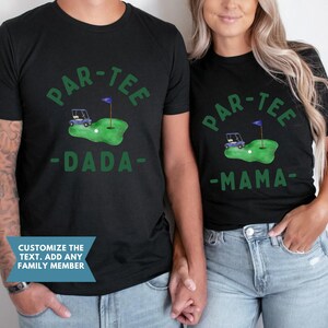 May include: Black t-shirts with a green golf-themed design. The shirts feature the text "PAR-TEE" above a golf course graphic with a golf cart, ball, and flag. One shirt says "DADA" and the other says "MAMA".