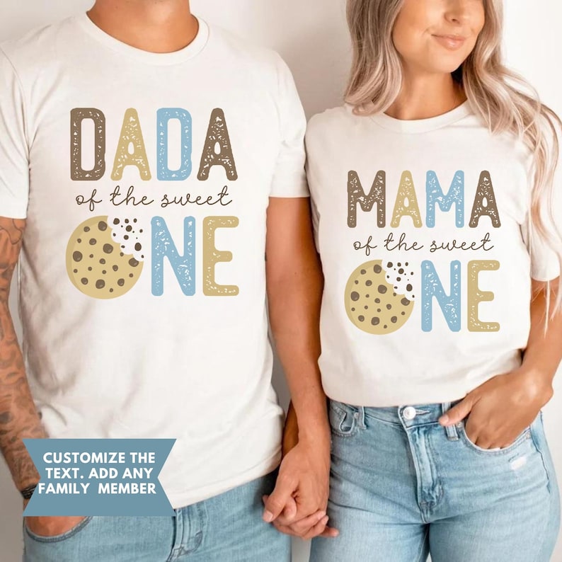 May include: Two white t-shirts with matching designs. One shirt says "DADA of the sweet ONE" and the other says "MAMA of the sweet ONE". Each shirt features a cookie graphic. The text "CUSTOMIZE THE TEXT. ADD ANY FAMILY MEMBER" is also visible.