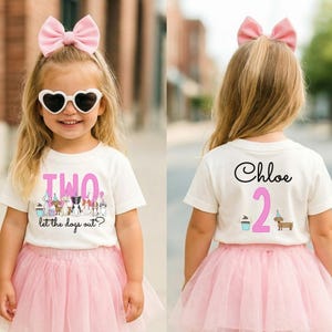 May include: A young girl wearing a white t-shirt with the word "TWO" and a dog graphic, paired with a pink tutu and bow. The back of the shirt has the name "Chloe" and the number "2". She is also wearing heart-shaped sunglasses.