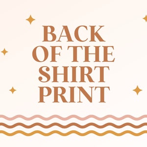 May include: A white background with a brown text overlay that reads "BACK OF THE SHIRT PRINT". The text is surrounded by small gold stars. The bottom of the image features a wavy line pattern in pink, brown, and gold.