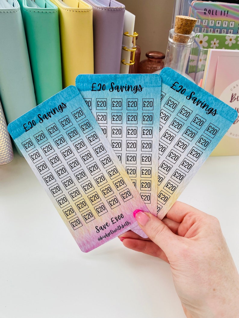 May include: Four colorful cards with a watercolor background and a grid of squares. Each square has the text "&pound;20" written inside. The cards are labeled "&pound;20 Savings" and the bottom card has the text "Save &pound;800 @budgetswithbeth".