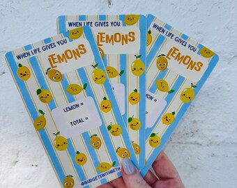 May include: Three rectangular budget tracker cards featuring a light blue and white vertical striped pattern with small yellow cartoon lemons. The text reads WHEN LIFE GIVES YOU LEMONS, LEMON =, TOTAL =, and @BUDGETSWITHBETH.