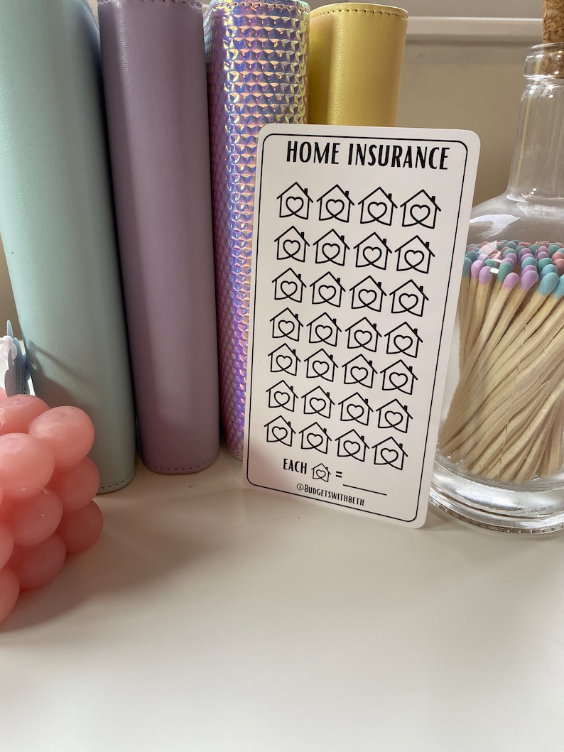 May include: A white card with the text "HOME INSURANCE" printed in black. The card has 25 black and white house icons with hearts inside. The text "EACH  =  " is printed below the icons. The text "@BUDGETSWITHBETH" is printed below the line.