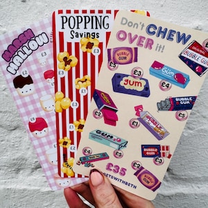May include: Three illustrated cards featuring sweets and snacks. One card shows marshmallows, another popcorn, and the third bubble gum. Text includes "Marshmallow", "Popping Savings", and "Don't CHEW OVER it!"