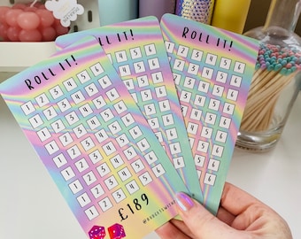 May include: Three rainbow holographic cards with the text "Roll It!" and a grid of numbers from 1 to 6. The cards are held in a hand. The bottom card has a price tag of £189 and two dice.