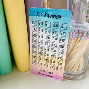 May include: A colorful card with a rainbow gradient background and the text "&pound;10 Savings" at the top. The card is divided into 40 squares, each containing the text "&pound;10". The bottom of the card reads "Save &pound;400" and "@budgetswithbeth".