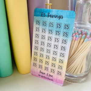 May include: A colorful card with a watercolor background and a grid of 25 squares. Each square contains the text "&pound;5" and the card says "&pound;5 Savings" at the top and "Save &pound;200 @budgetswithbeth" at the bottom.
