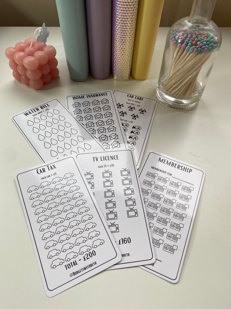 May include: A set of black and white printable budget trackers with icons for water, home insurance, car care, car tax, TV license, and membership. Each tracker has a total cost listed at the bottom.