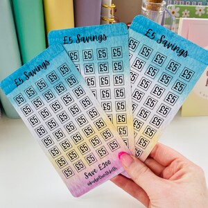 May include: Five colorful cards with a watercolor background. Each card has a grid of squares with the text "&pound;5" written inside each square. The cards are labeled "&pound;5 Savings" and the bottom card has the text "Save &pound;200" and "@budgetswithbeth".