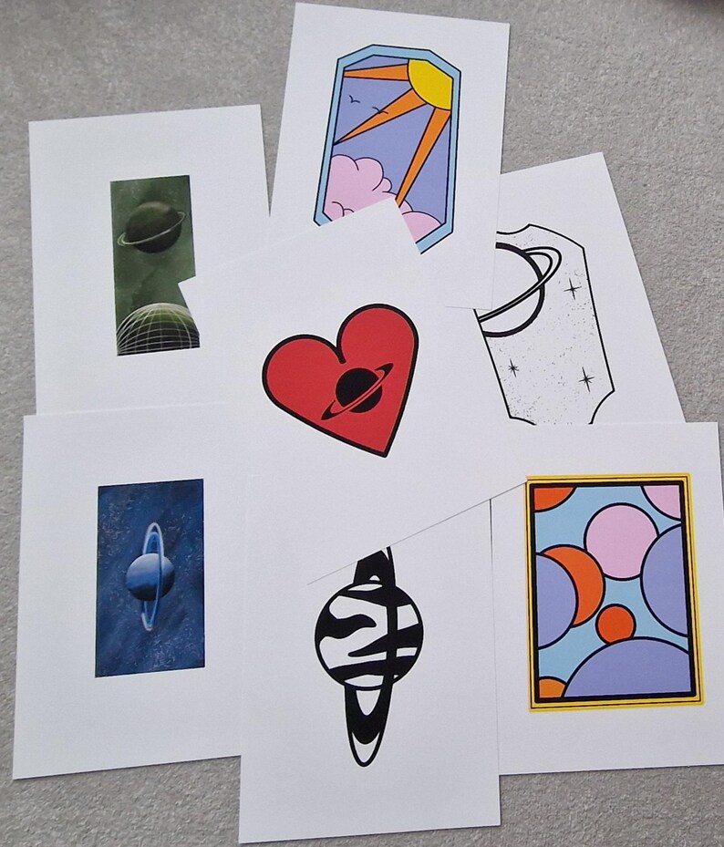 May include: Set of 7 printable art prints featuring a variety of colorful and abstract designs with a space theme. Each print features a planet with rings, a heart, a sun, and a variety of geometric shapes.