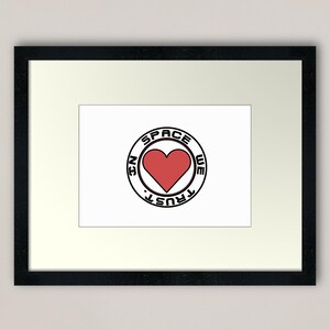 May include: A black and white graphic design with a red heart in the center. The graphic says "In Space We Trust" in a circle around the heart.