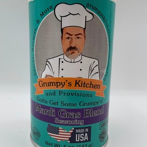 May include: A teal blue can with a yellow lid and a cartoon chef on the front. The can is labeled "Grumpy's Kitchen and Provisions" and "Mardi Gras Blend Seasoning". The can is made in the USA and weighs 5 ounces (142 grams).