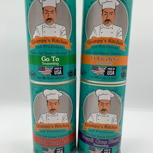 May include: Four colorful spice jars with a cartoon chef on each label. The jars are labeled "Grumpy's Kitchen and Provisions" and each jar has a different seasoning: "Go To", "Et Etcetera", "BBQ Butt Rub", and "Mardi Gras Blend".
