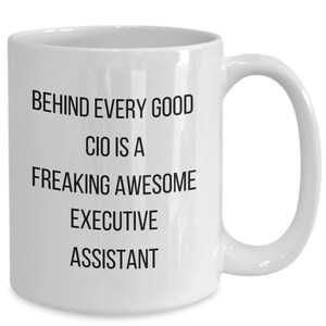 May include: White ceramic coffee mug with black text that reads "Behind every good CIO is a freaking awesome executive assistant."